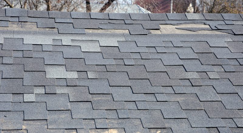 Close up view of roof shingles with wind damage